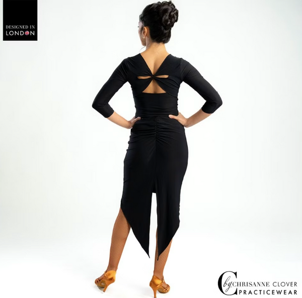 This sleek and form-fitting Latin skirt showcases beautiful ruching at the back, enhancing your silhouette. It features a dramatic long tail centre back split that contrasts nicely with the knee-length, streamlined front. This design not only flatters your figure but also allows for the dynamic movements you need on the dance floor, all while being secured by a comfortable elasticated branded waistband.