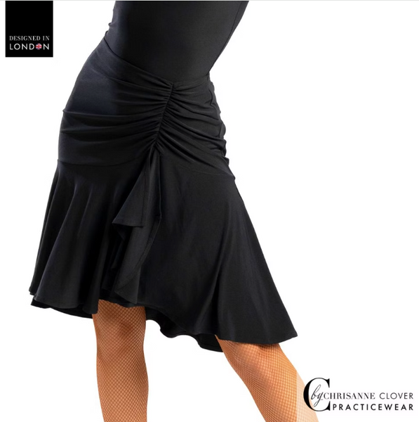 This knee-length Latin skirt showcases a flattering ruched front panel that elegantly scoops and gathers to the left, enhancing the silhouette of the wearer. The flared skirt, complete with a split on the left side, cascades gracefully from the ruched waistband, allowing for fluid movement and a captivating appearance.