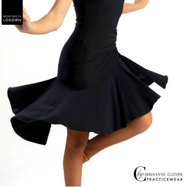 This knee-length Latin skirt showcases a flattering ruched front panel that elegantly scoops and gathers to the left, enhancing the silhouette of the wearer. The flared skirt, complete with a split on the left side, cascades gracefully from the ruched waistband, allowing for fluid movement and a captivating appearance.