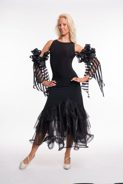 Free Australia-wide shipping. Best price worldwide.

RS Atelier Pepper black organza ballroom skirt

Add elegant movement to your dance wardrobe with the RS Atelier Pepper. This black Italian ballroom skirt features layered organza ruffles and pairs beautifully with a leotard or dance top for practice and performance.

Details
Women's black ballroom skirt with layered organza ruffles