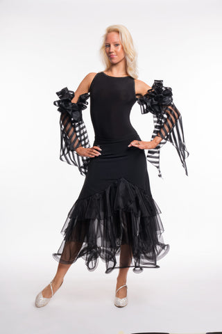 Free Australia-wide shipping. Best price worldwide.

RS Atelier Pepper black organza ballroom skirt

Add elegant movement to your dance wardrobe with the RS Atelier Pepper. This black Italian ballroom skirt features layered organza ruffles and pairs beautifully with a leotard or dance top for practice and performance.

Details
Women's black ballroom skirt with layered organza ruffles