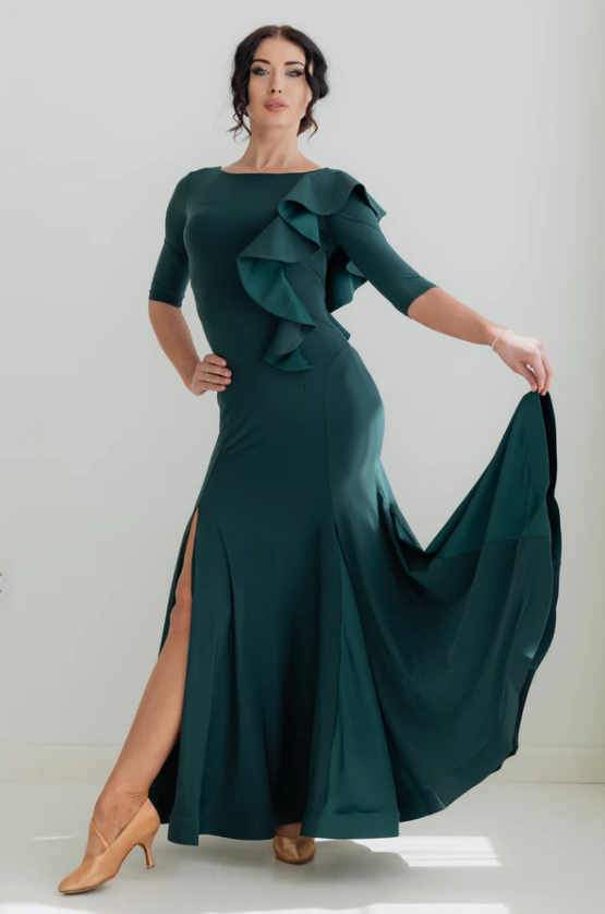 the Federica Ruffle Gown in Emerald Smoke is designed for dancers who know that presence is everything. Whether you're stepping onto the competition floor for your first DanceSport competition, performing at a showcase, or attending a formal evening event, this gown delivers effortless sophistication and graceful movement in equal measure.

A sweeping, wide skirt with delicate mesh inserts flows beautifully as you move, while the horsehair trim and cascading ruffle detail add layers of glamour that catch th