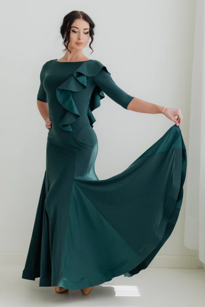 the Federica Ruffle Gown in Emerald Smoke is designed for dancers who know that presence is everything. Whether you're stepping onto the competition floor for your first DanceSport competition, performing at a showcase, or attending a formal evening event, this gown delivers effortless sophistication and graceful movement in equal measure.

A sweeping, wide skirt with delicate mesh inserts flows beautifully as you move, while the horsehair trim and cascading ruffle detail add layers of glamour that catch th