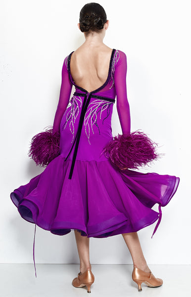 Hot magenta junior ballroom dress, with crystallized leaf pattern, in Swarovski AB and Purple crystals.  Lycra, stretch net and georgette fabrics paired with ostrich feather cuffs and georgette ribbons. The skirt is 3/4 length, perfect for tall and petite dancers as well.