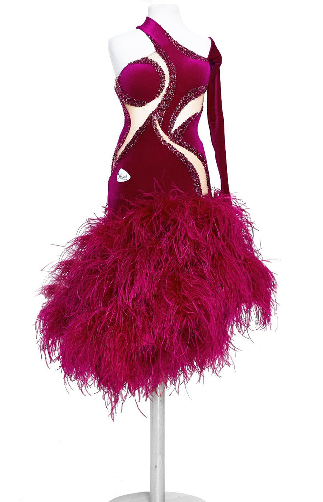 Special junior and youth latin dress with full ostrich feather skirt in fuchsia pink, top in smooth velvet with stretch net nude insertions. The body is decorated with Fuchsia, Fuchsia Ab and Rose Swarovski crystals along the nude insertions. Full back, asymmetrical sleeve and slit on the skirt, perfect for Junior II and youth category dancesport.