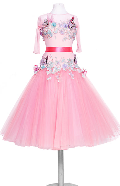 Junior ballroom dress, in sugar pink, with tulle stiff net pleated skirt, decorated with pastel coloured flowers, petals, and butterflies.  Pink satin ribbons around the wrists and waist.   This stunning, fully completed, ready to wear Junior Ballroom DanceSport Competition Dress can be created in any colour and size.
